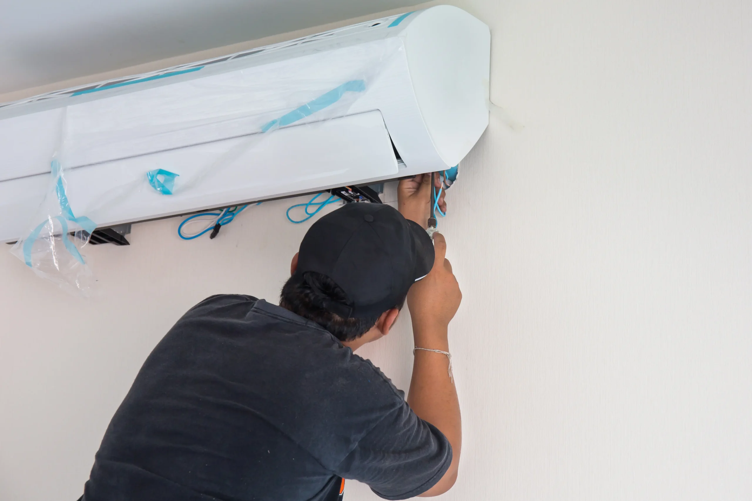 Rite Price Technician fixing wall-mounted split system air conditioner